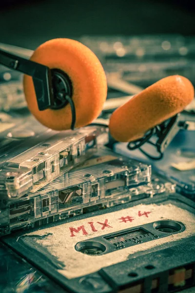 Stack of old cassette tape with red headphones — Stock Photo, Image