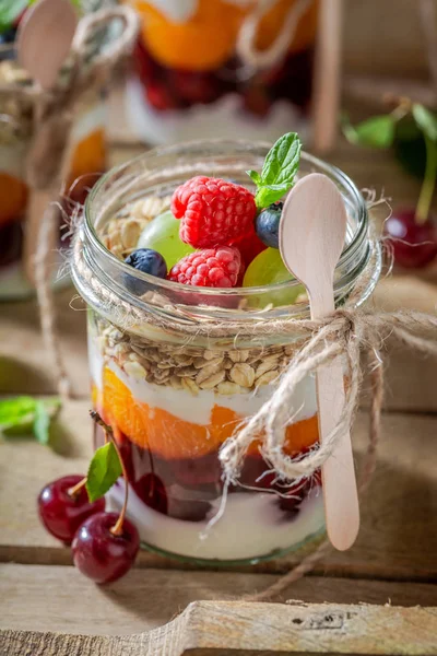 Homemade oat flakes with fresh berries and yoghurt in jar — Stock Photo, Image