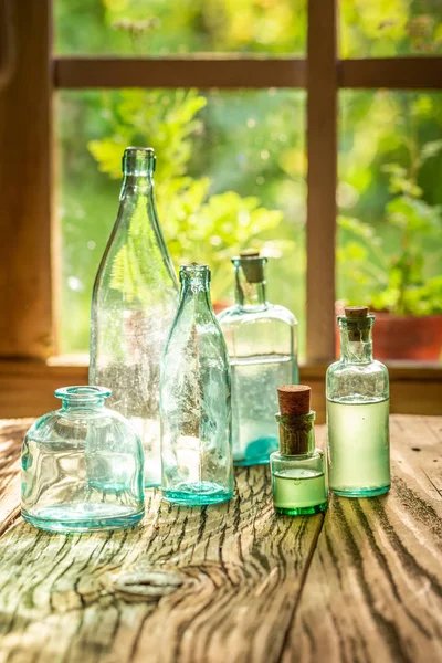 Empty bottles of tinctures on a rustic table — Stock Photo, Image