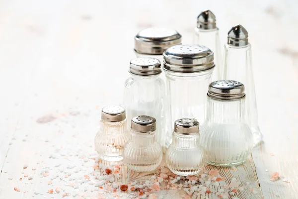 Closeup of Iodized salt in salt cellar on white table — Stock Photo, Image