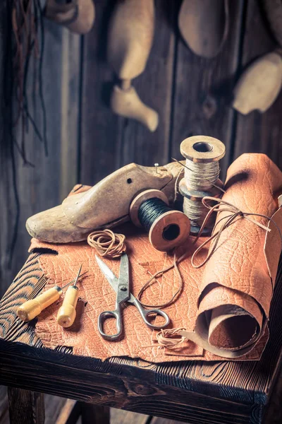 Närbild på skomakare arbetsplats med verktyg, skor och läder — Stockfoto