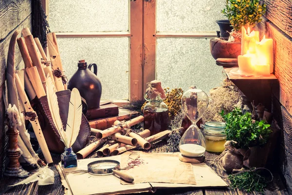 Vintage witch workshop with scrolls and plants — Stock Photo, Image