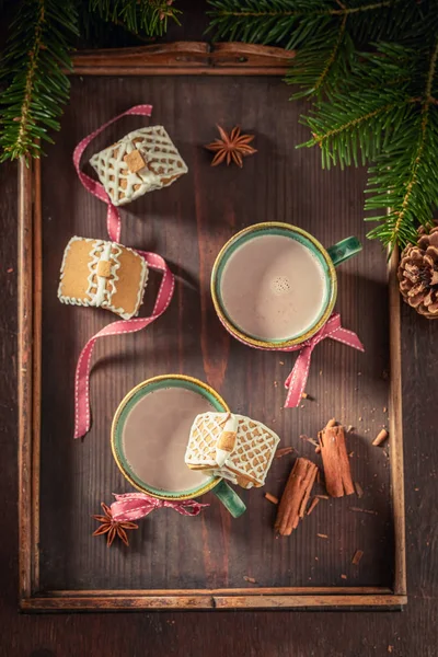 Cute gingerbread cottages with tasty chocolate as Christmas snack — Stock Photo, Image