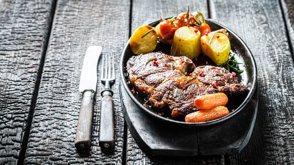 Sült Steak Zöldségekkel Égett Asztalon — Stock Fotó