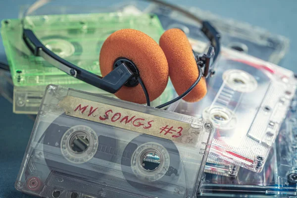 Vintage Pile Cassette Tapes Orange Headphones Blue Sofa — Stock Photo, Image
