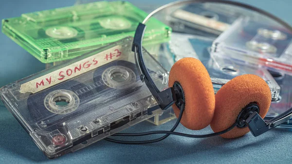 Classic Pile Cassette Tapes Orange Headphones Blue Sofa — Stock Photo, Image