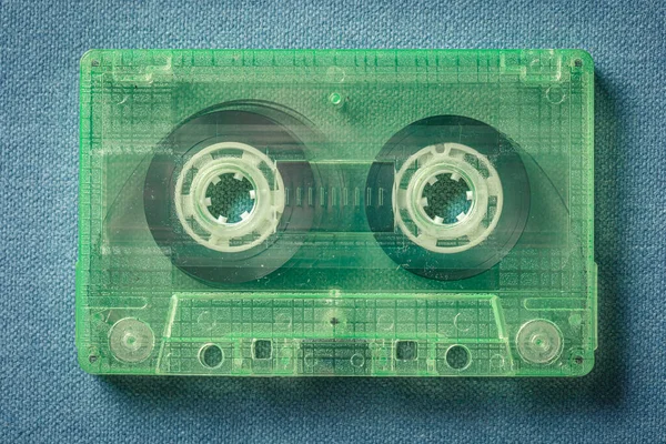 Closeup One Green Audio Cassettes Blue Sofa — Stock Photo, Image