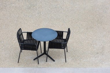 İki boş siyah sandalye ve beton yukarıdan bir masada