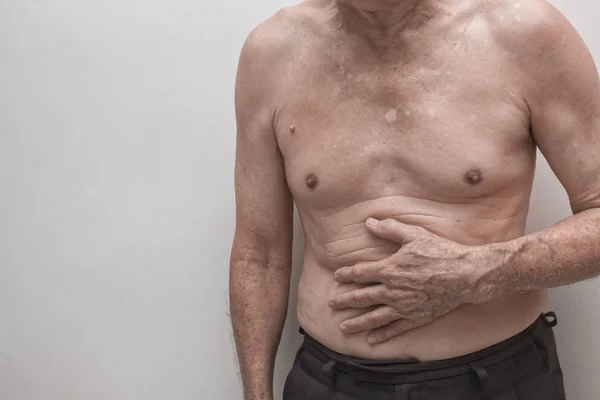 Elderly man having abdominal pain, upset stomach or menstrual cramps