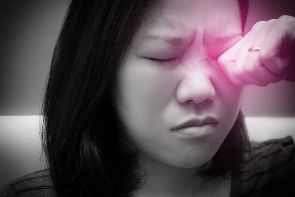 Asian woman rubbing her eye. Black and white tone and red spot on her eyes. Concept of eye\'s problem, dust allergy, dry eye, watery, itching or contact lenses problem