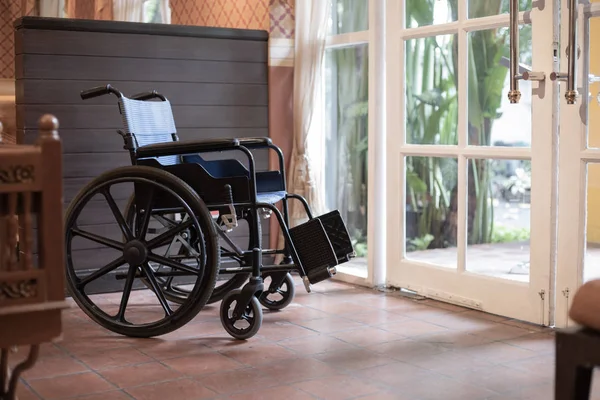 Empty wheelchair in front of the restaurant. Preparing for disable customers