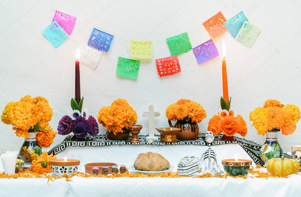 Day of the dead altar with pan de muerto and candles