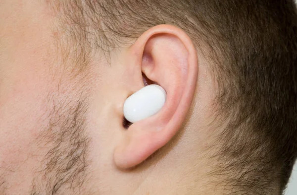 Wireless earpiece in guy\'s ear