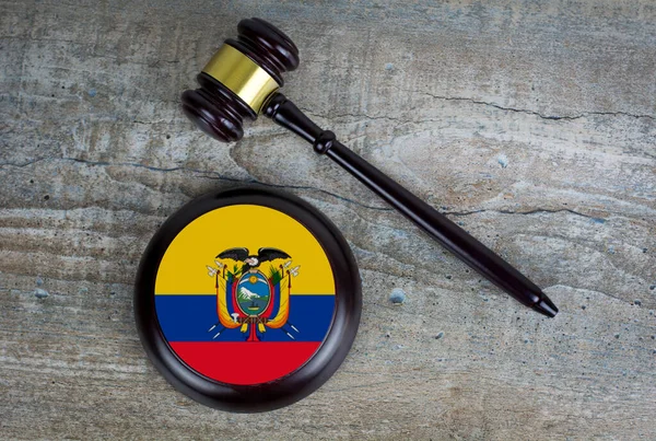 Wooden judgement or auction mallet with of Ecuador flag. Conceptual image