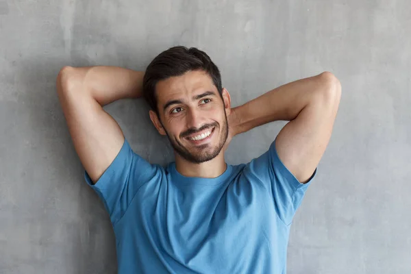 Portrét Pohledný Usměvavý Mladý Muž Modrém Tričku Opřený Šedý Texturovaný — Stock fotografie