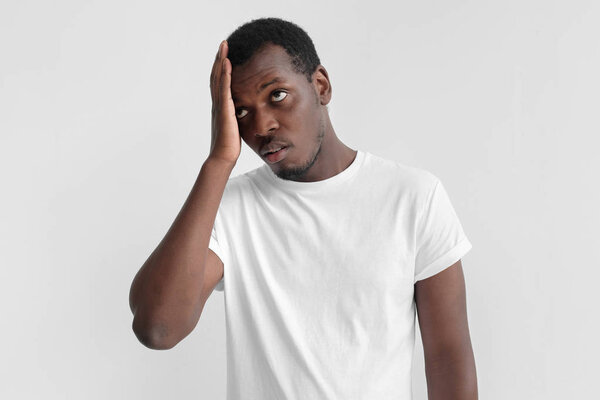 Face palm concept. Young african american man feeling bad about unpleasant situation
