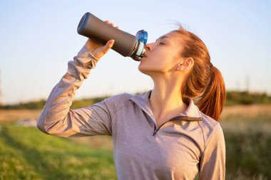 Egzersiz içme suyu sonra genç bir kız 