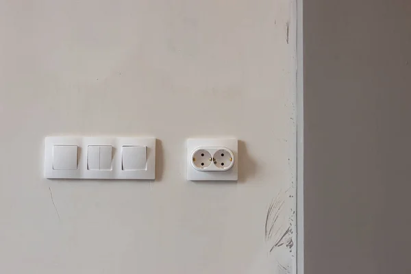 white sockets and switches on the wall being repaired