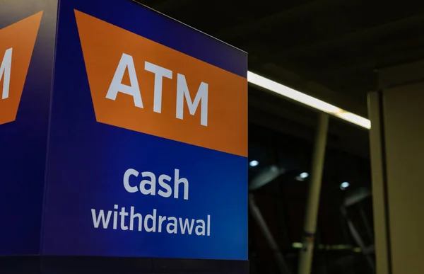 A picture of the ATM logo inside the terminal of the Warsaw Chopin Airport.