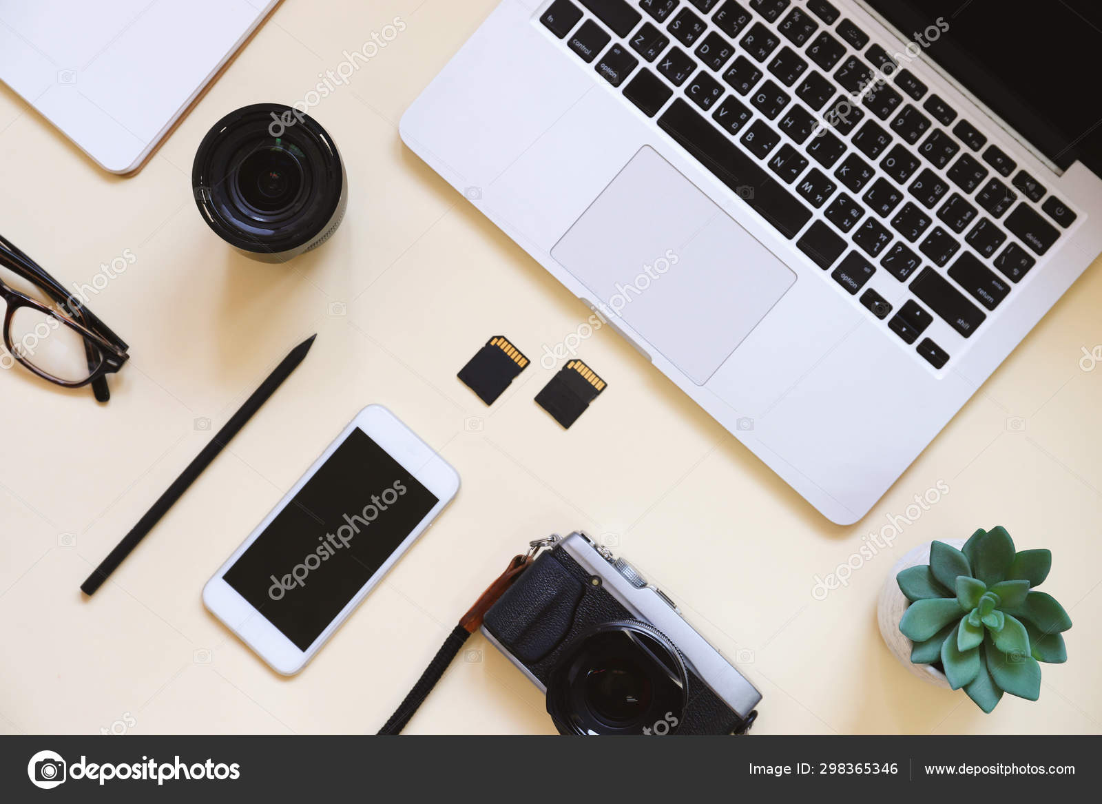 Desktop flat lay photo of workspace desk with laptop, camera, ta