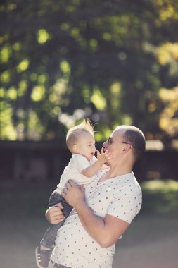 parkta oynarken oğluyla mutlu baba