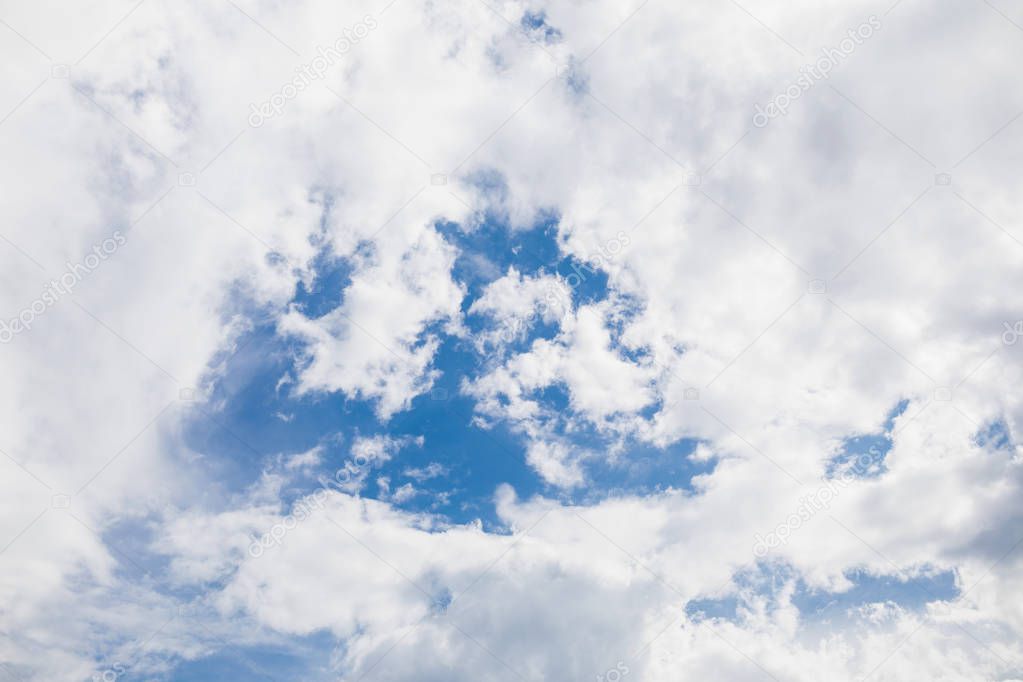 Blue sky background with tiny clouds.