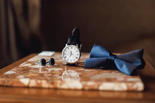 Accessories: butterfly, cufflinks,watch for a classic suit