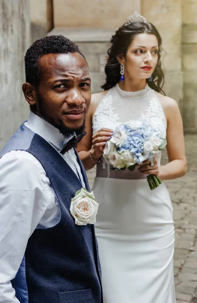 Wedding day. Stylish african groom and his pretty bride. African wedding couple emotional portrait loving bride and groom.