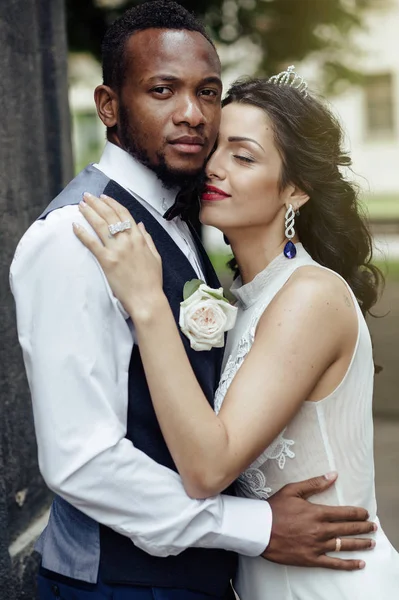 Wedding day. Stylish african groom and his pretty bride. African wedding couple emotional portrait loving bride and groom.