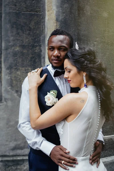 Wedding day. Stylish african groom and his pretty bride. African wedding couple emotional portrait loving bride and groom.