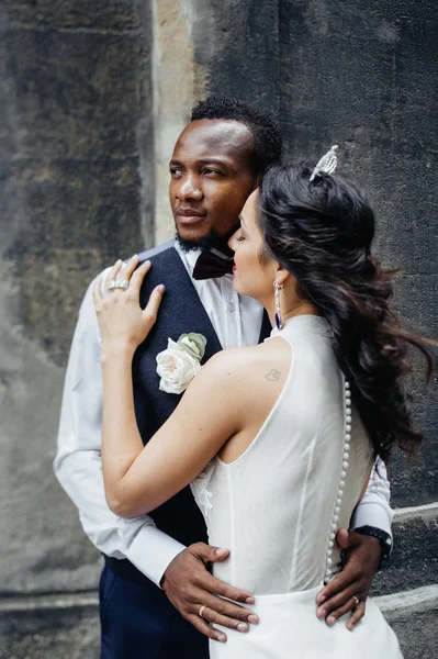 Wedding day. Stylish african groom and his pretty bride. African wedding couple emotional portrait loving bride and groom.