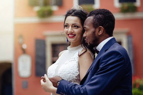 Wedding day. Stylish african groom and his pretty bride. African wedding couple emotional portrait loving bride and groom.