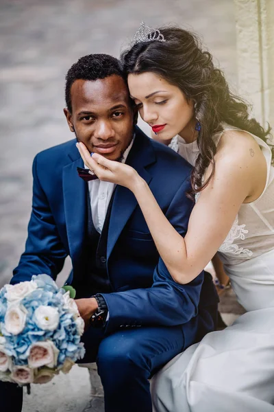 Wedding day. Stylish african groom and his pretty bride. African wedding couple emotional portrait loving bride and groom.