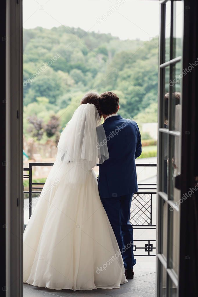 Wedding couple. Beautiful wedding couple on the balcony