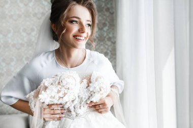 Gelin Düğün sabahı. Beyaz lüks elbise içinde muhteşem gelin düğün için hazırlanıyor. Sabah hazırlıkları.