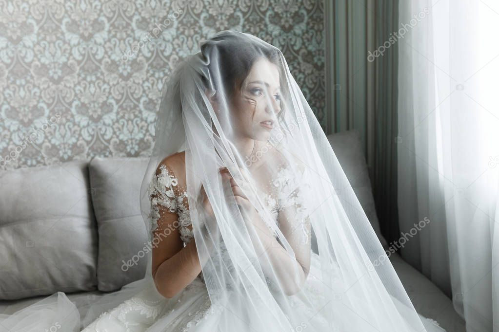 Closeup portrait of young gorgeous bride. Portrait of beautiful bride, morning preparations.