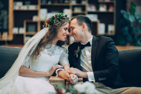 Emotional wedding couple in cafe having fun together.