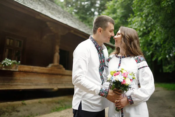 Beautiful bride and groom in the ukrainian style are standing w