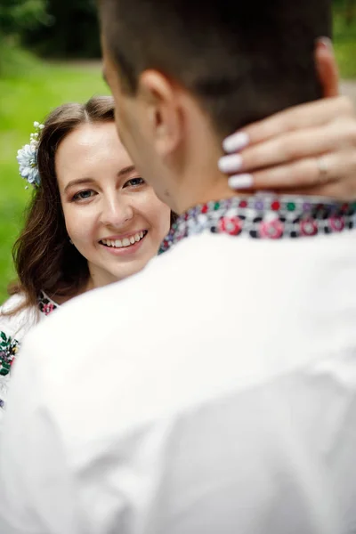 Beautiful bride and groom in the ukrainian style are standing w