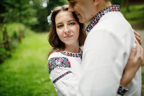 Beautiful bride and groom in the ukrainian style are standing w