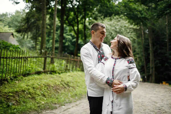 Beautiful bride and groom in the ukrainian style are standing w