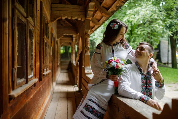 Beautiful bride and groom in the ukrainian style are standing w