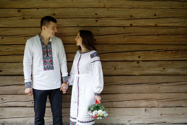 Beautiful bride and groom in the ukrainian style are standing w