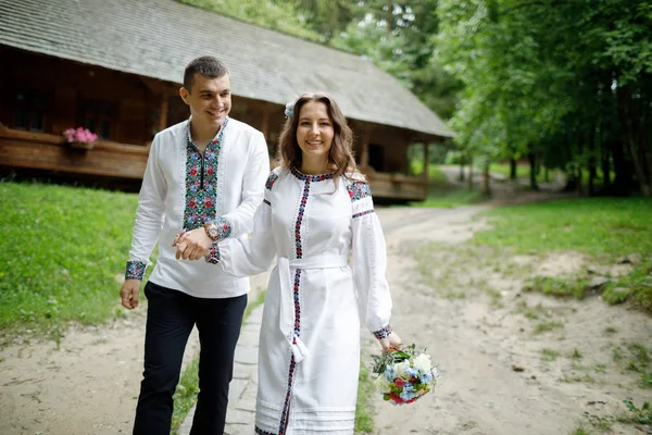 Beautiful bride and groom in the ukrainian style are standing w