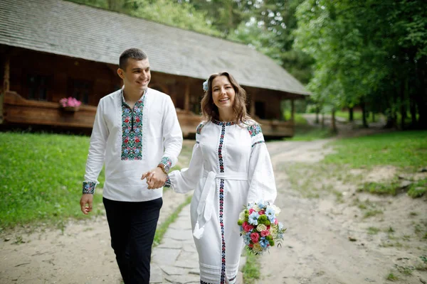 Beautiful bride and groom in the ukrainian style are standing w