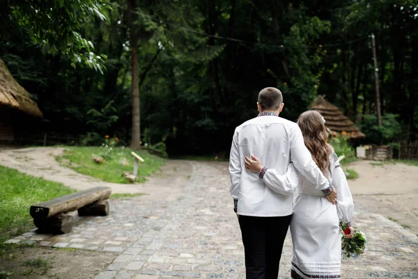 Beautiful bride and groom in the ukrainian style are standing w