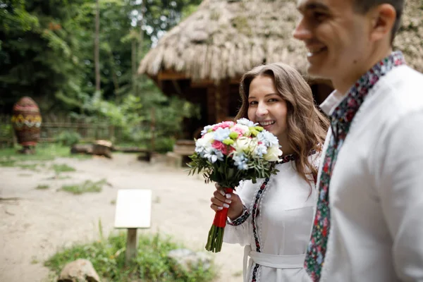 Beautiful bride and groom in the ukrainian style are standing w