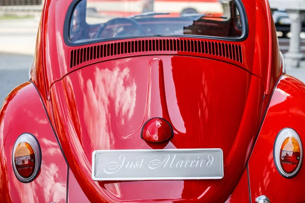 Vintage wedding car with just married sign and cans attached