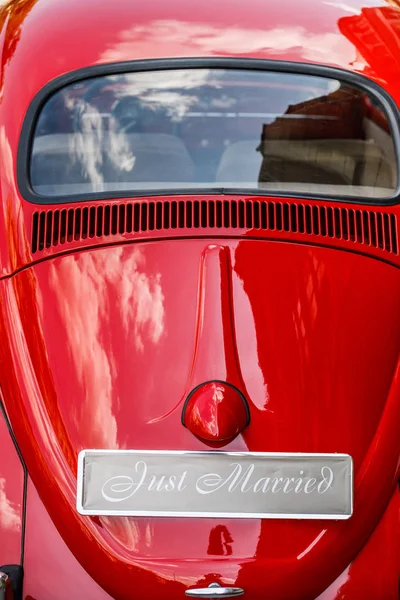 Vintage wedding car with just married sign and cans attached