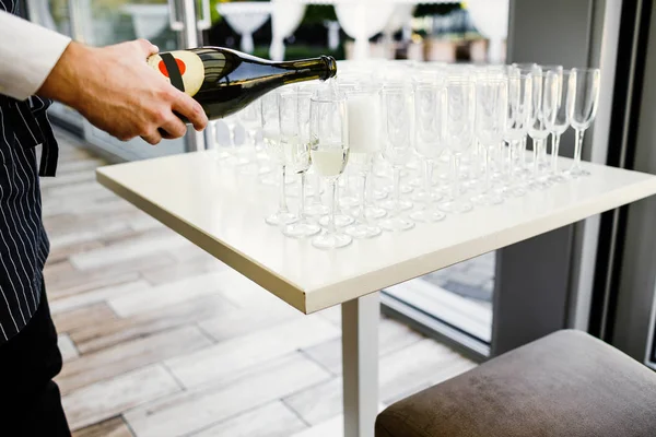Elegant glasses with champagne standing in a row on serving tabl — Stock Photo, Image